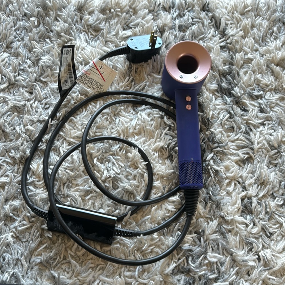 Dyson hair dryer with case and attachments.